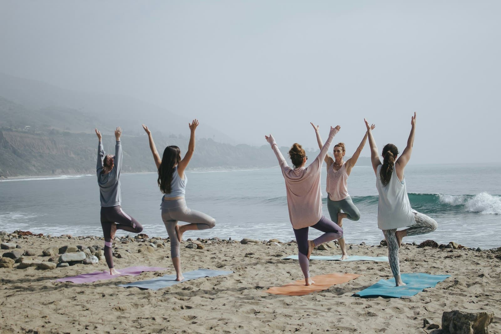A small class practicing on the beach